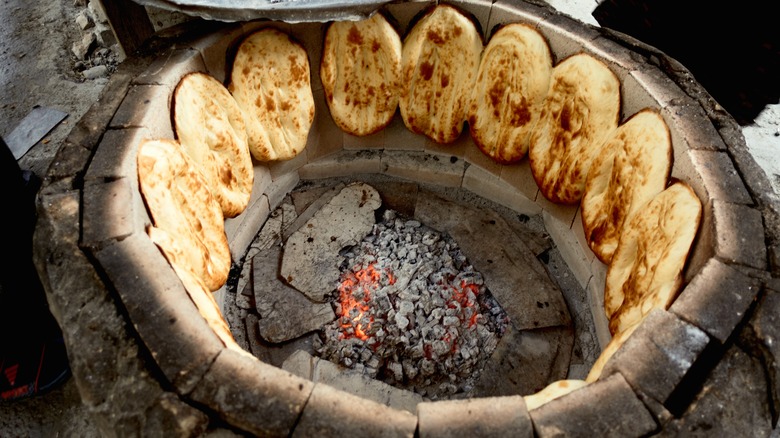 Tandoor oven with bread in