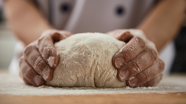 Person kneading bread