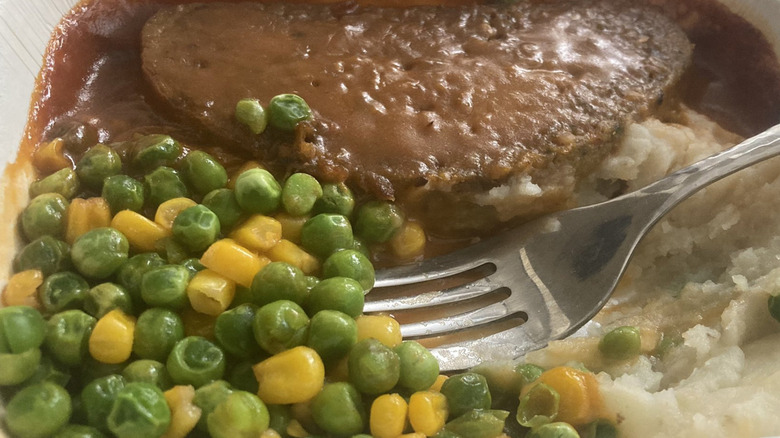 Salisbury steak TV dinner with corn and peas