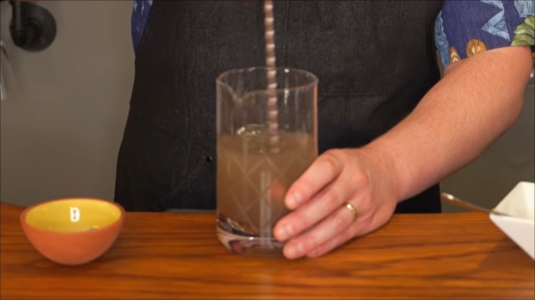 Man mixing ash into liquid