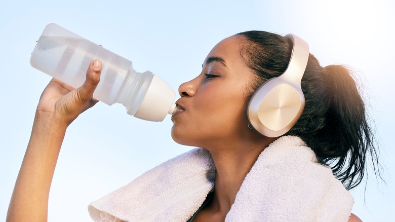 Woman drinking from sports bottle