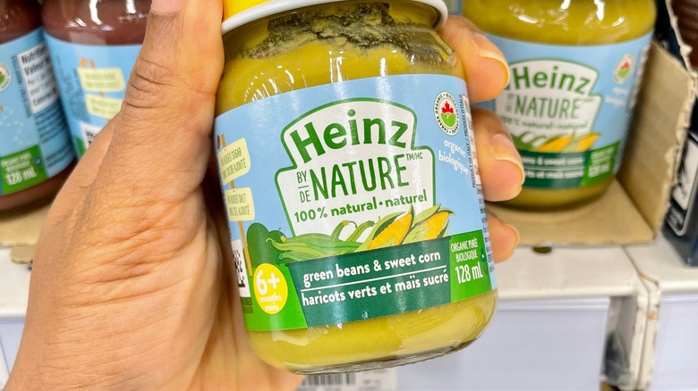 Handheld jar of Heinz baby food