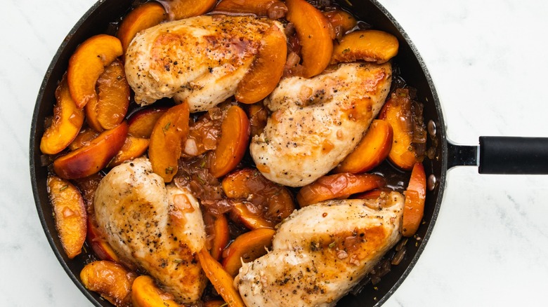 Chicken and peaches in skillet