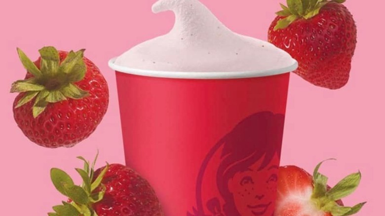 The new Strawberry frosty with strawberries surrounding it