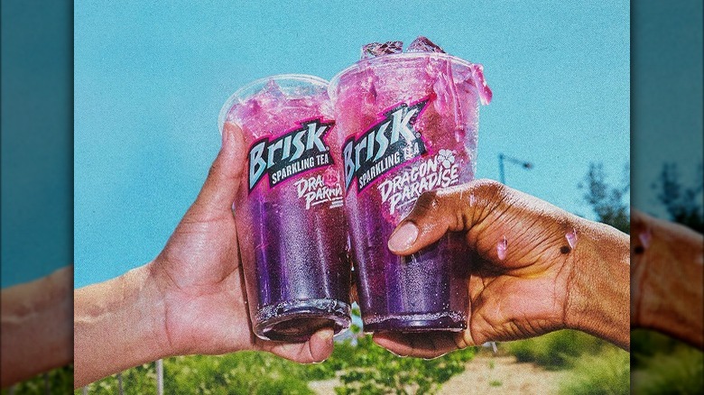 Two people holding Brisk Tea