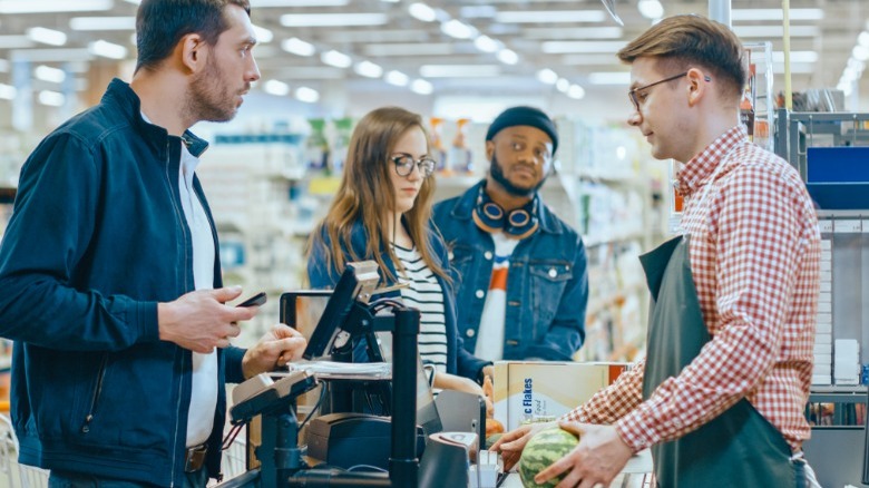 Customers standing in line at checkout counter