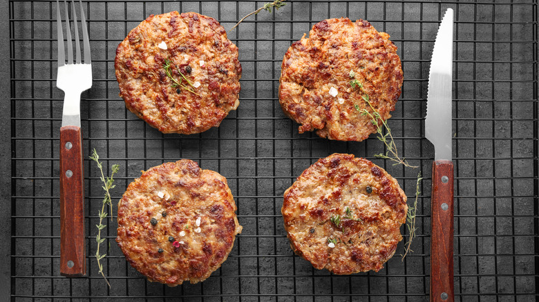 Grilled burger patties with knife and fork