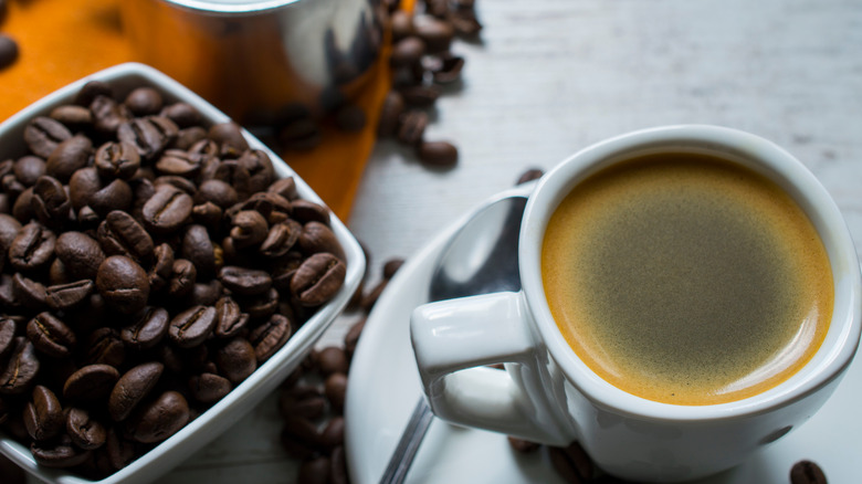 Cup of Pete's Coffee next to bowl of coffee beans