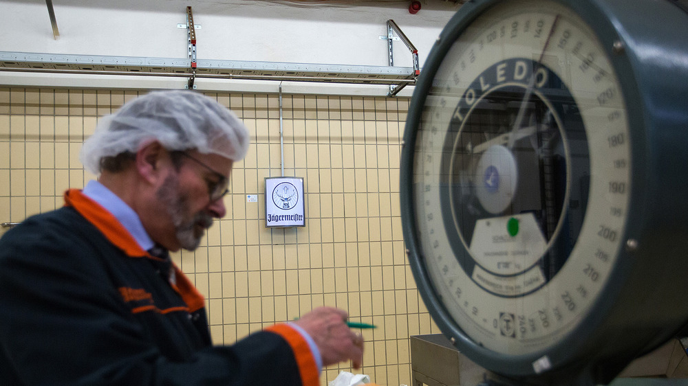 Jägermeister master distiller weighs ingredients