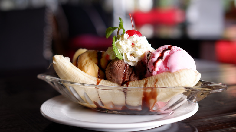 Banana split on wooden table