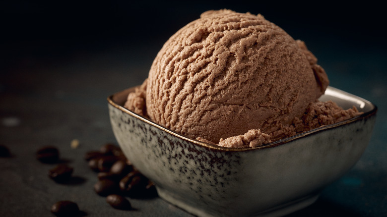 a scoop of chocolate ice cream on a black background