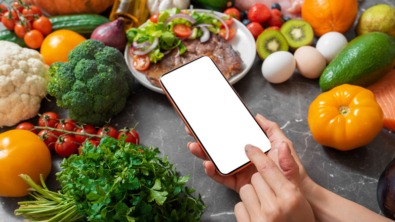 Phone in kitchen with vegetables