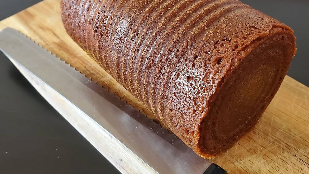 Canned bread on cutting board with knife