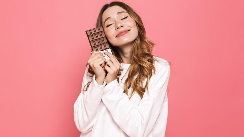 Woman hugging chocolate bar