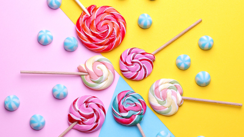 Various lollipops on a multi-colored background