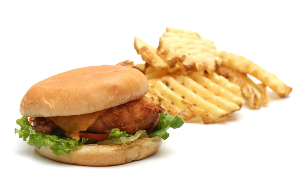 chicken sandwich with waffle fries in the background
