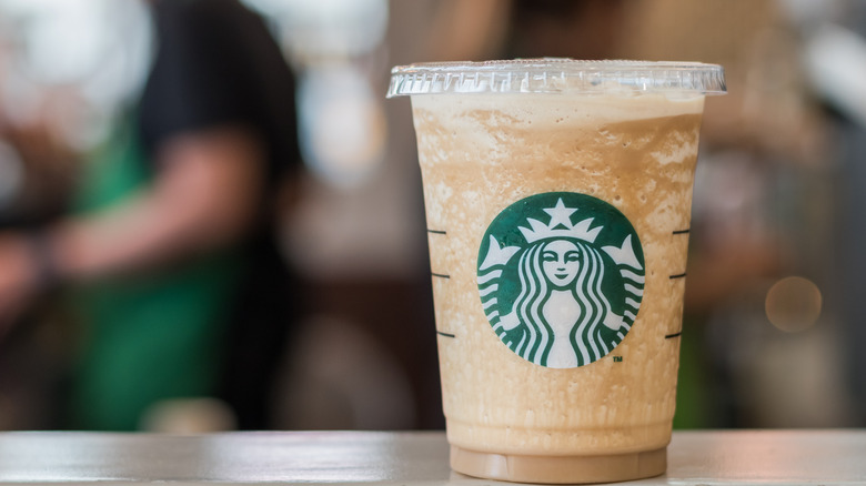 Starbucks drink employee in background