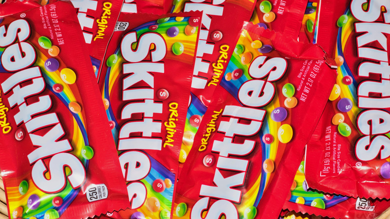 Bags of Skittles arranged on display