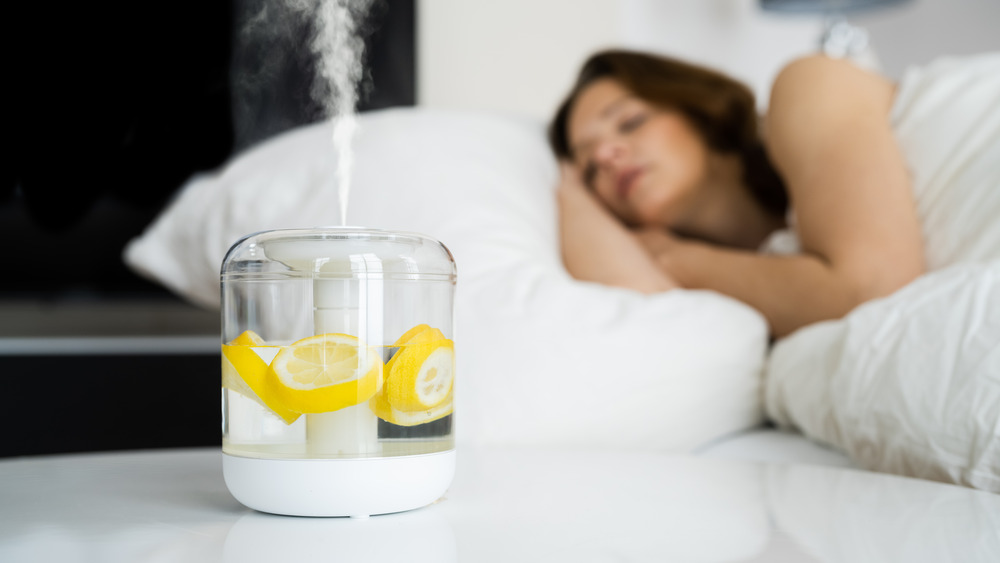 Woman sleeping with lemon water on nightstand