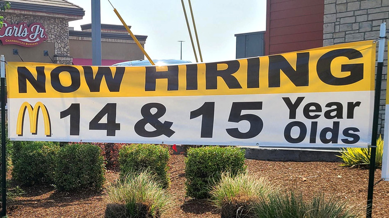 "Now hiring" banner outside McDonald's