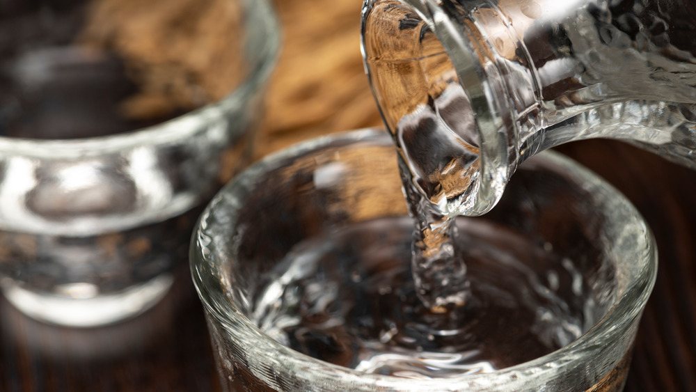 sake beverage being poured into glass