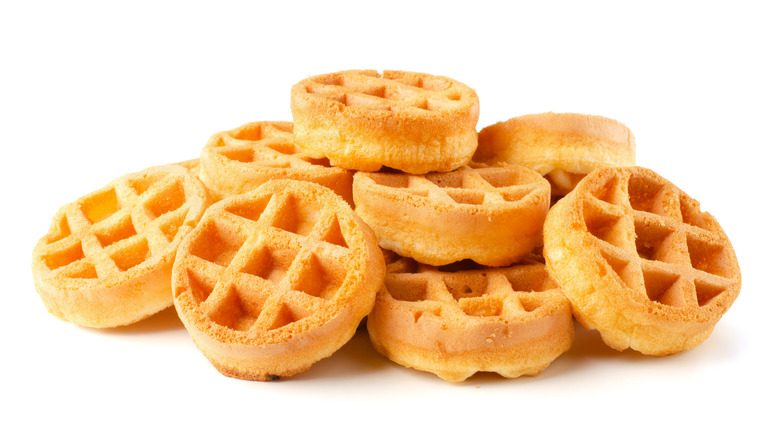 Mini waffles in a pile on white background