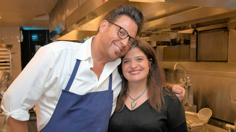 Scott Conant and Alex Guarnaschelli smiling in kitchen