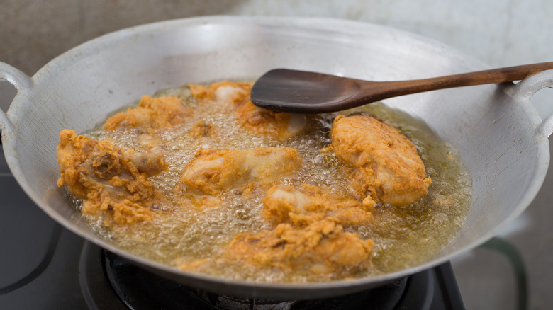 chicken frying in pan