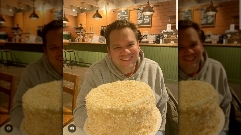 Photo of Harold Moore smiling with coconut cake