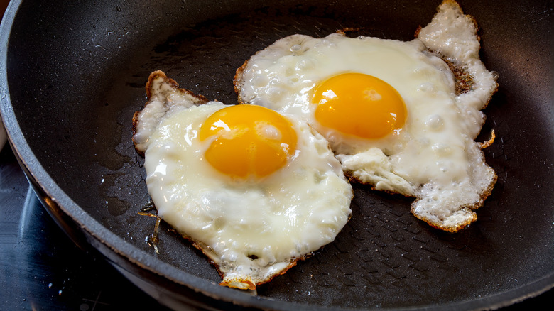 fried eggs in black pan