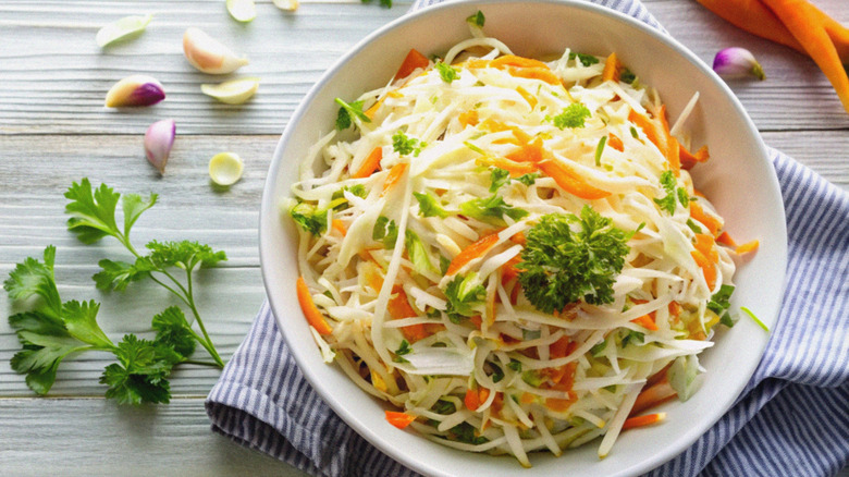 Colorful cabbage coleslaw on table