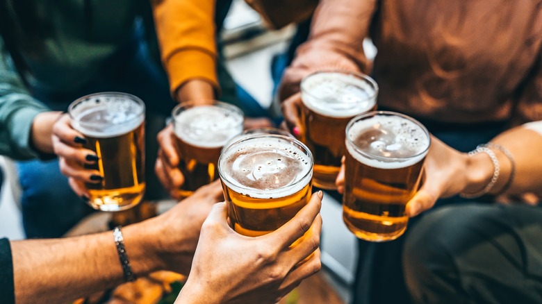 People holding pints of beer