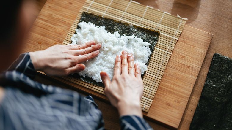 Person making sushi