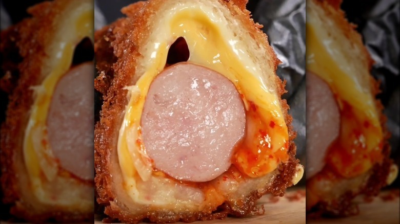 cross section of deep-fried hot dog with kimchi and cheese