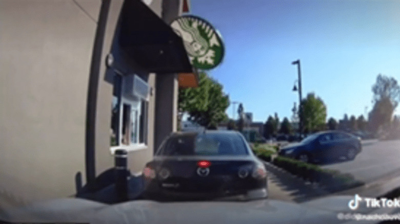 Starbucks sign falling on car 