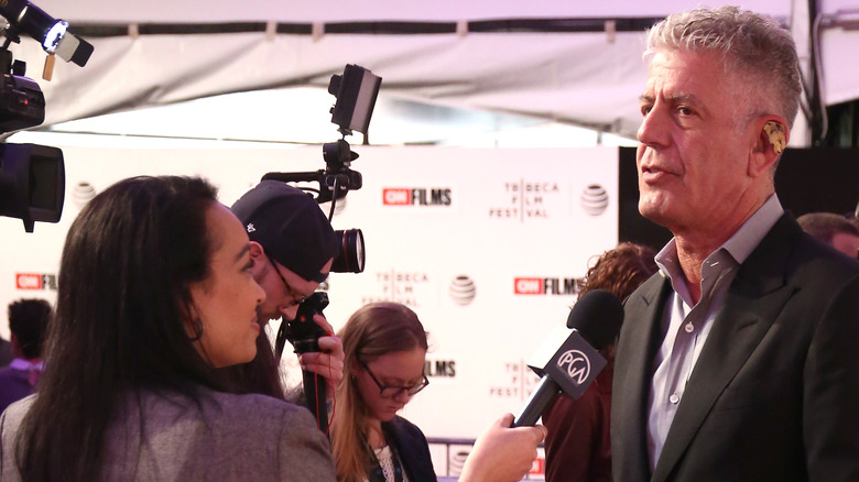 Woman interviewing Anthony Bourdain