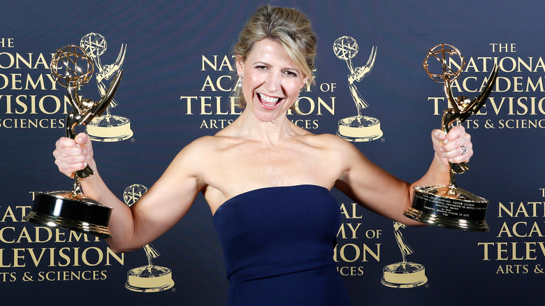 Samantha Brown holding two Emmys