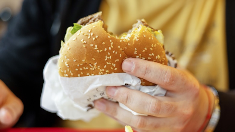 hand holding burger