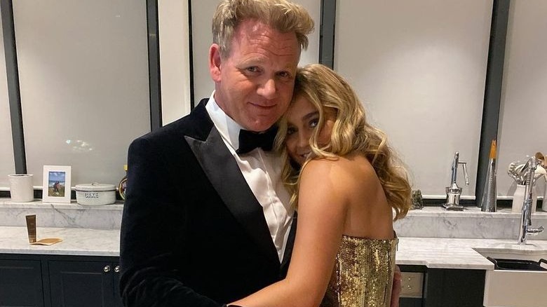 Matilda and Gordon Ramsay in formal attire hugging 