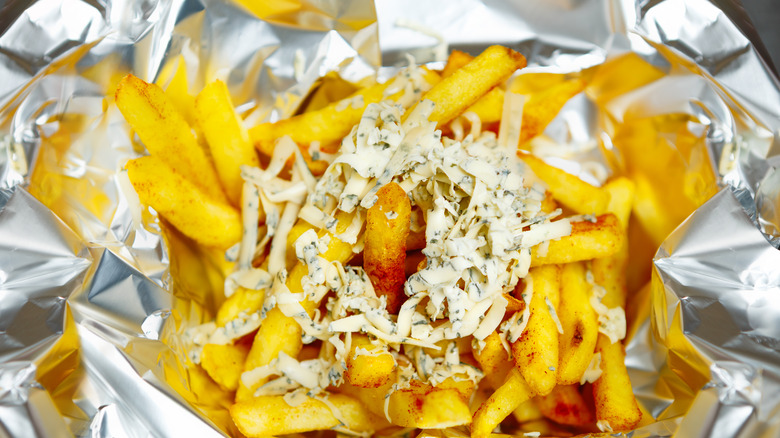 French fries cooked in foil being served