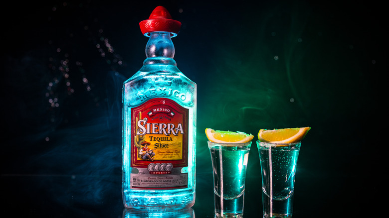 Sierra tequilla with 2 shot glasses and citrus wedges
