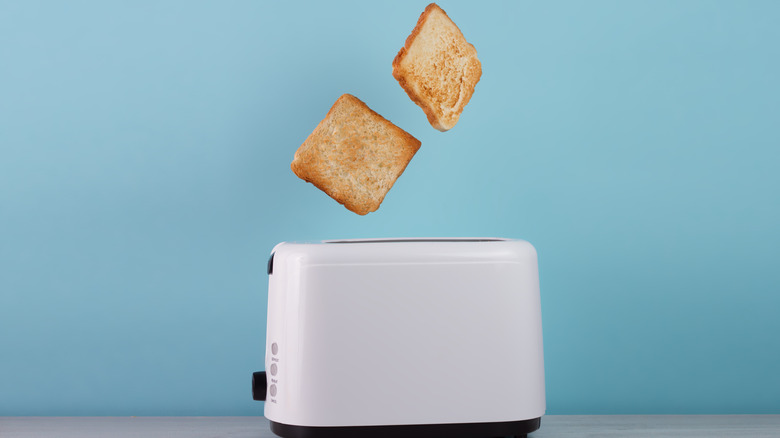 Golden toast flying from toaster