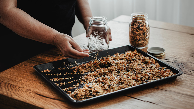 Hand filling jar with granola