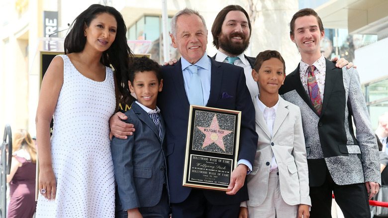 Wolfgang Puck (C), posing with wife designer Gelila Assefa (L) and his sons, is honored with a Star on the Hollywood Walk of Fame