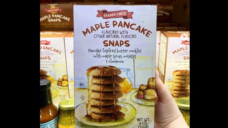 A hand holding a box of the new maple flavored cookies from Trader Joe's 