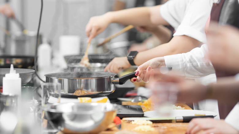 line cooks in kitchen