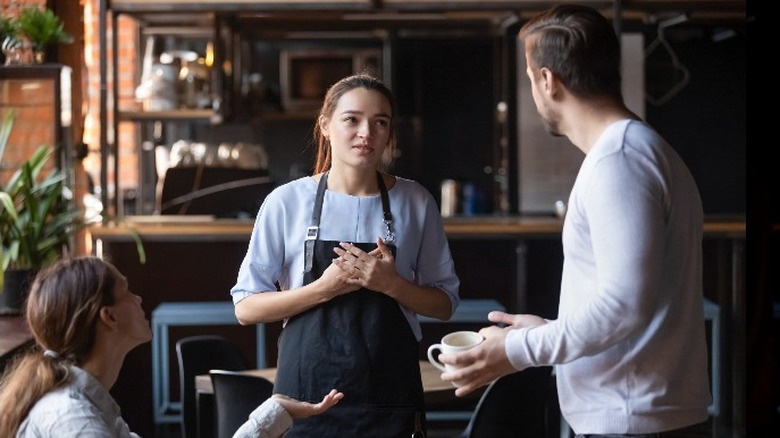 Angry customers confront worker