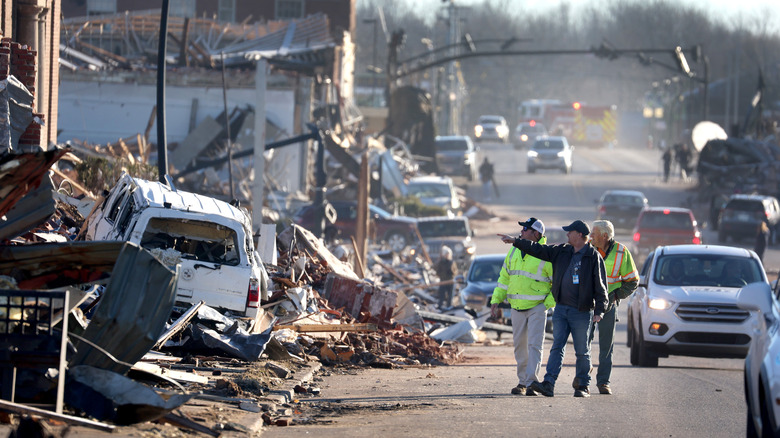 Workers reviewing tornado damage