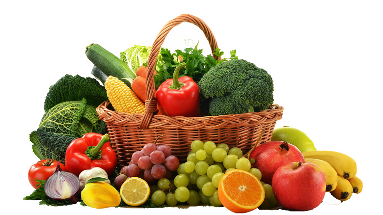 wicker basket of fruit on white background