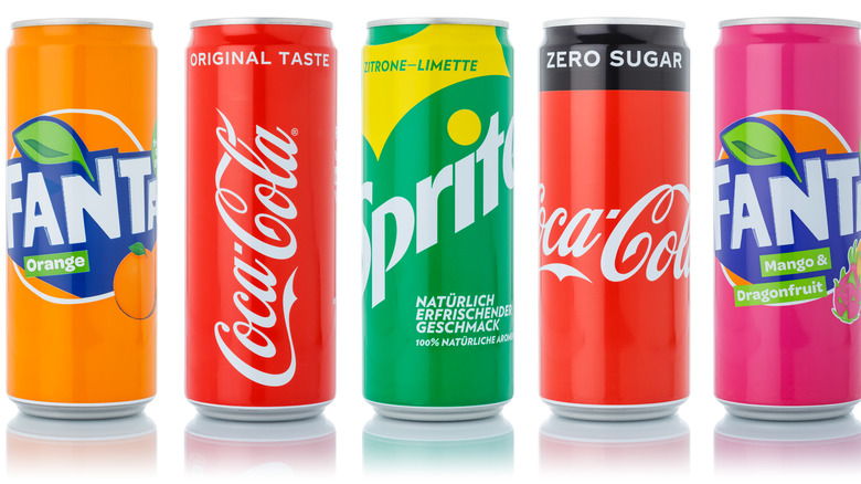 Cans of Orange Fanta, Coca-Cola, and Sprite